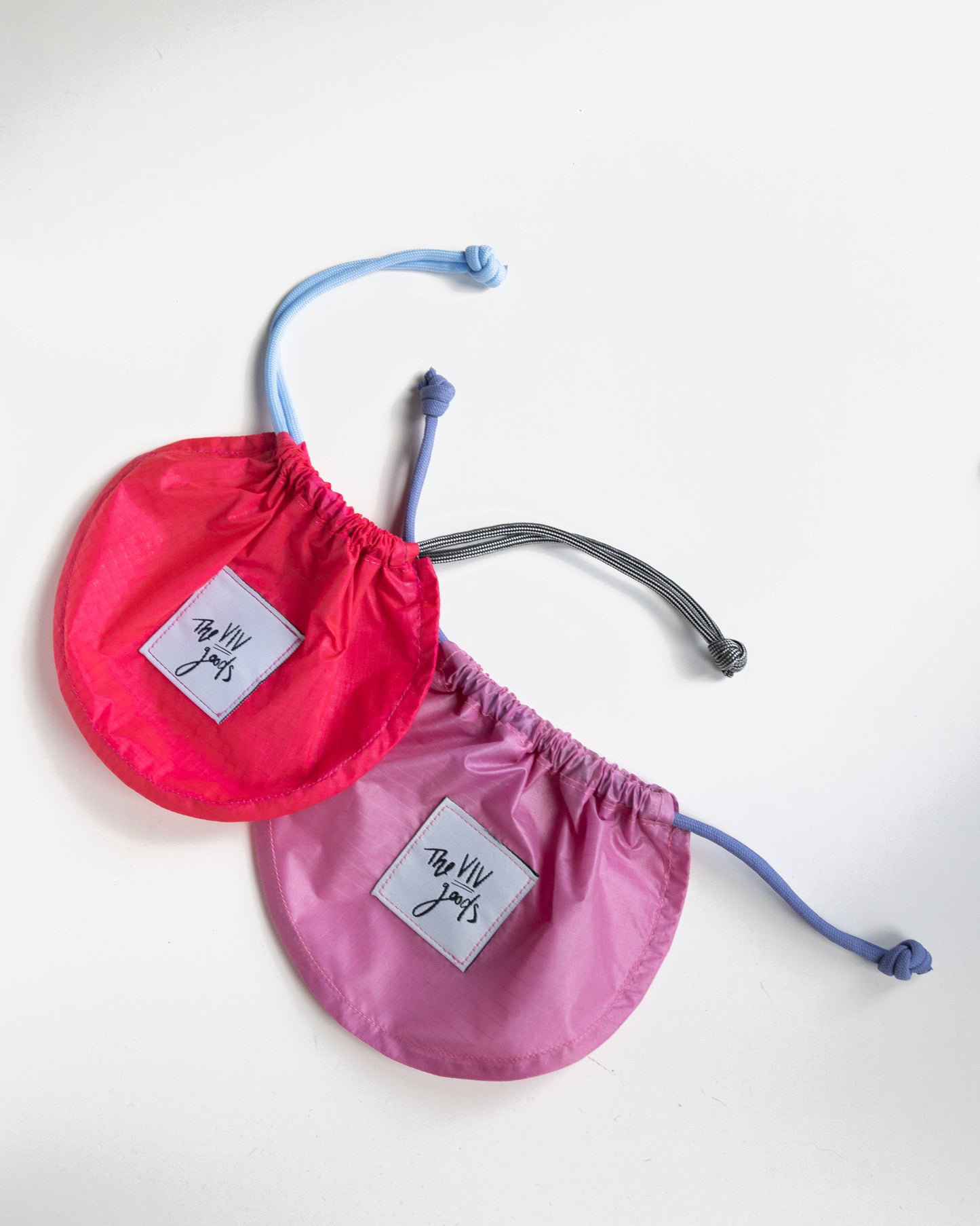 set of two draw string pouches made from rip stop nylon in light and dark pink