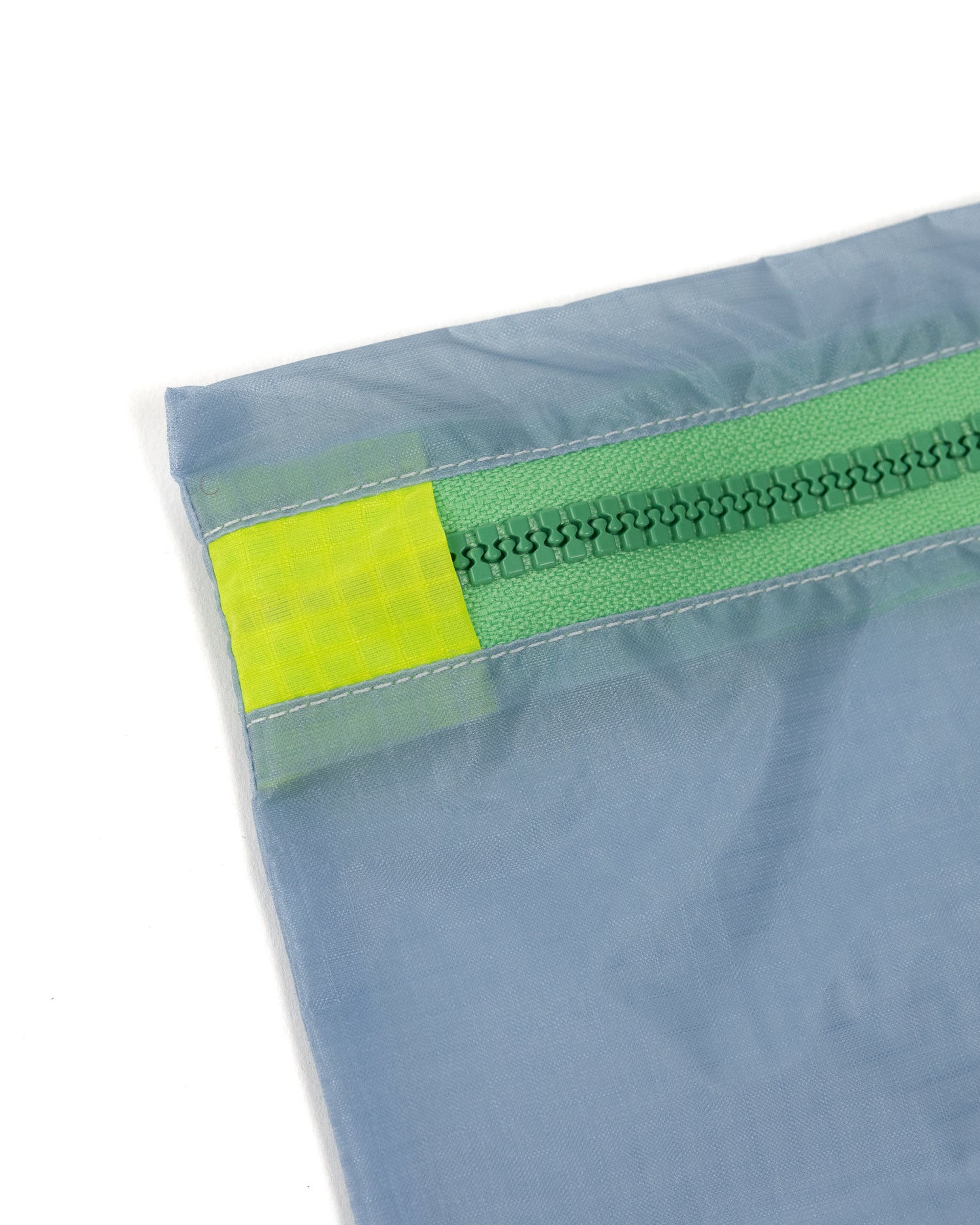 Grey and light green square zipper pouch made from upcycled ripstop nylon