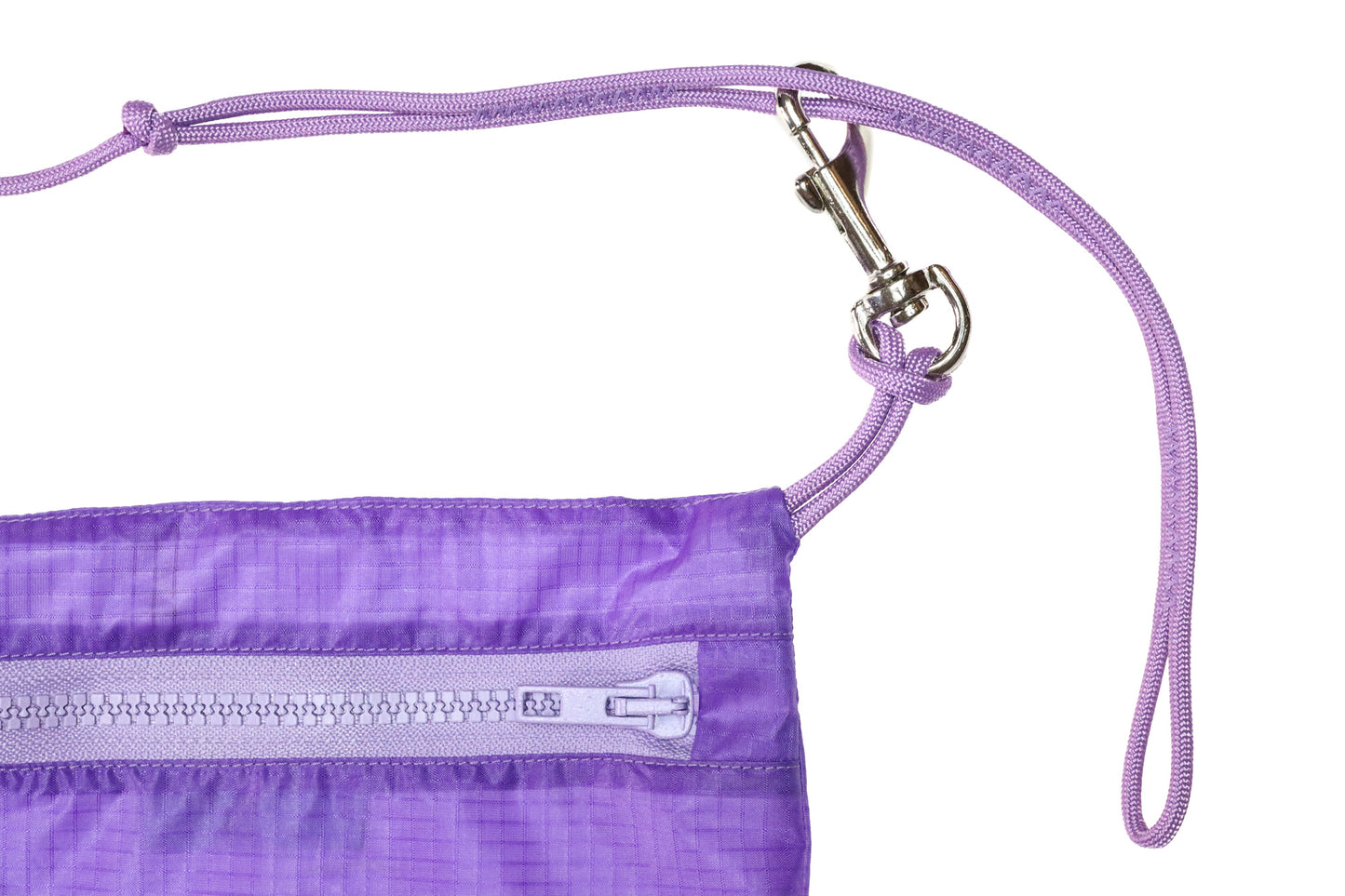 close up Flat lay crossbody bag in lavender made from recycled rip stop nylon