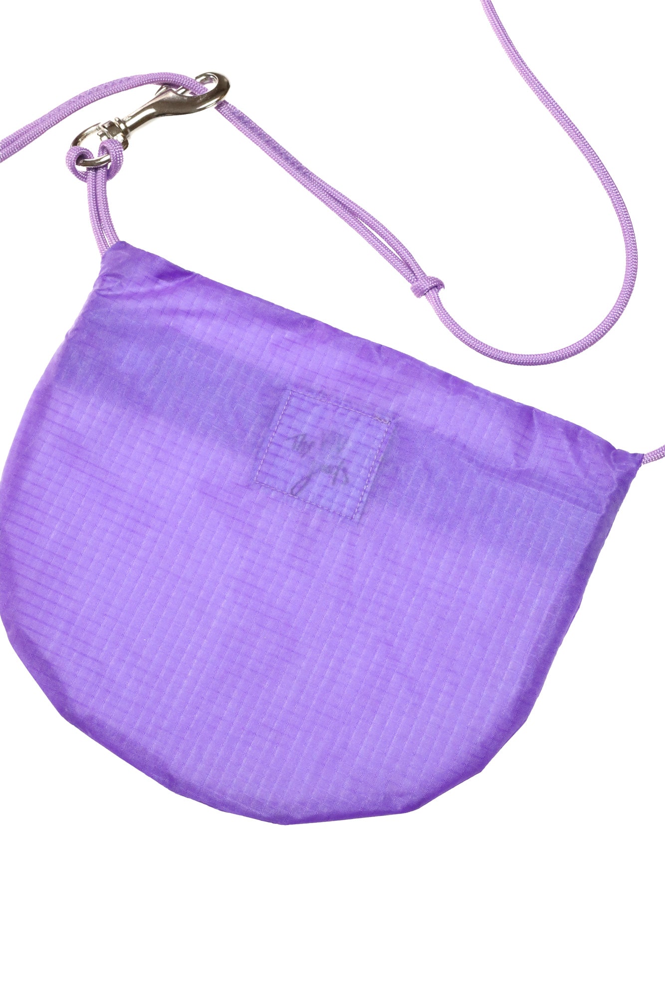Flat lay crossbody bag in lavender made from recycled rip stop nylon
