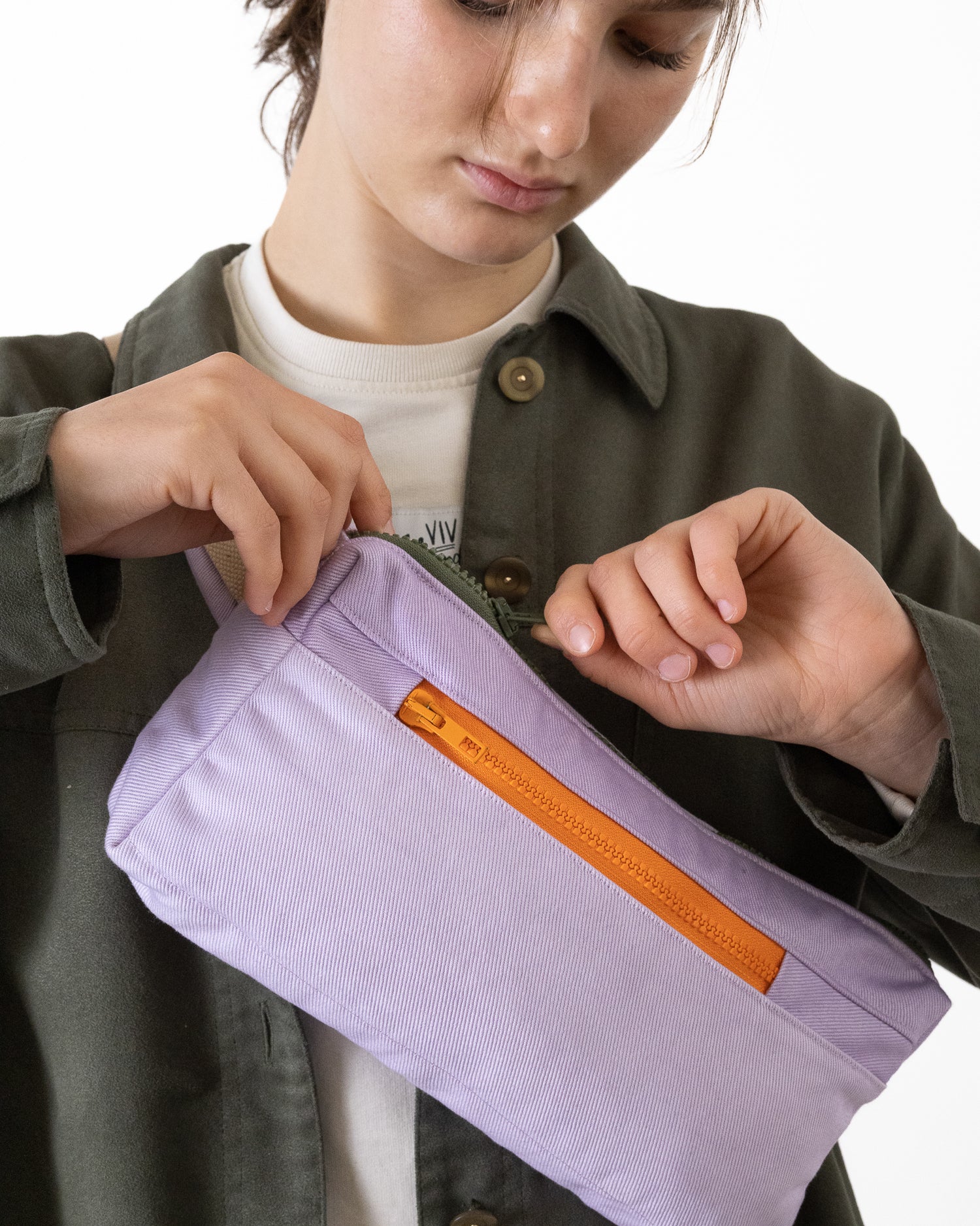 model wearing lavender bumbag with orange zipper made from reclaimed canvas