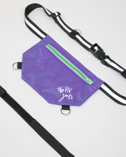 flat lay of the SPORT.BAG designed for runners in purple with a reflective strap and light green zipper